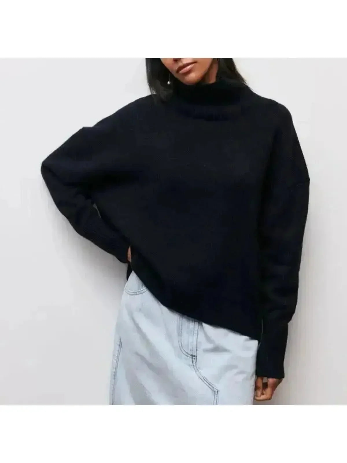 Oversized turtleneck sweater in Black, shown against a plain studio background