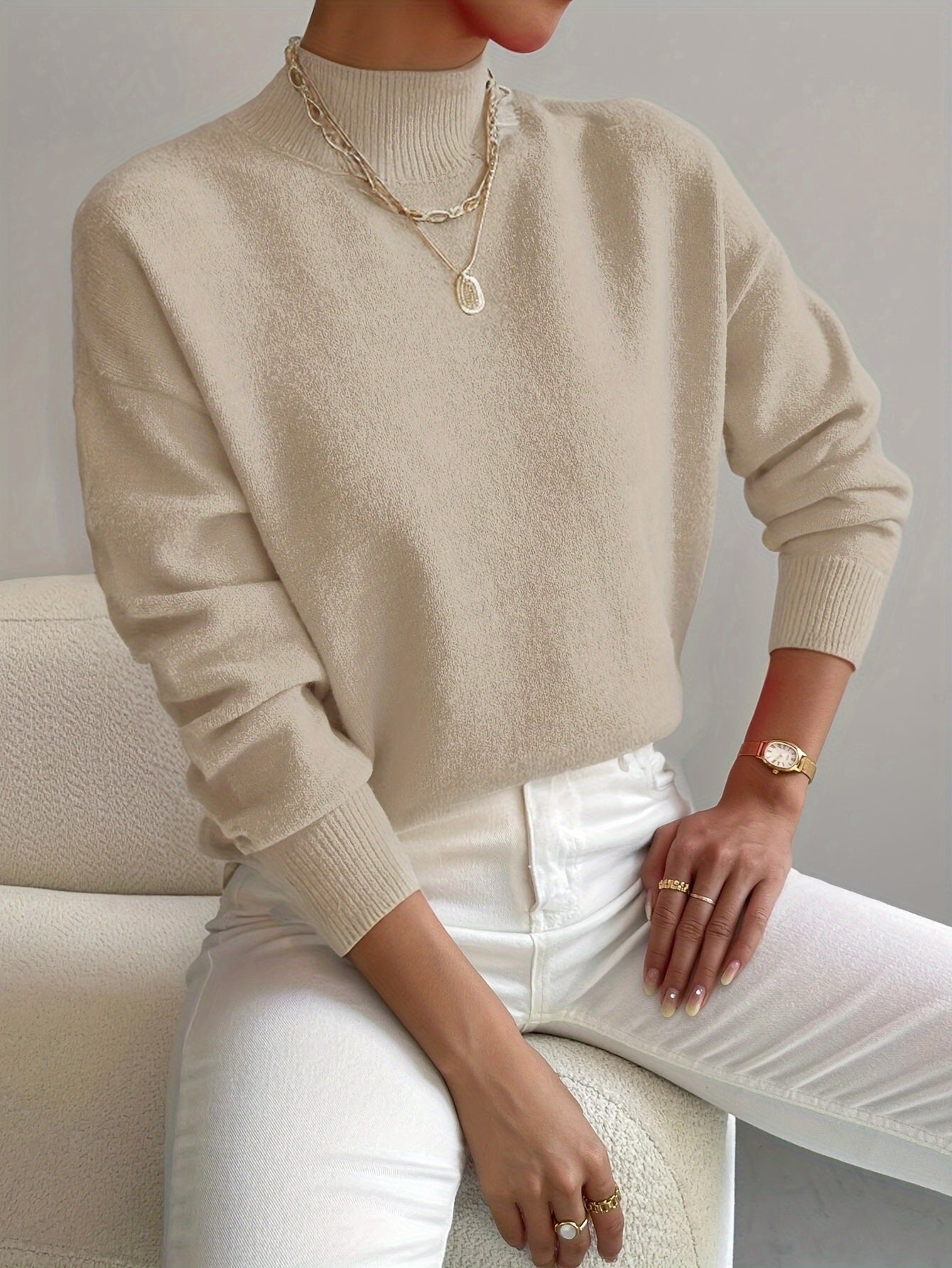 Turtleneck sweater for women in beige, front view worn with denim