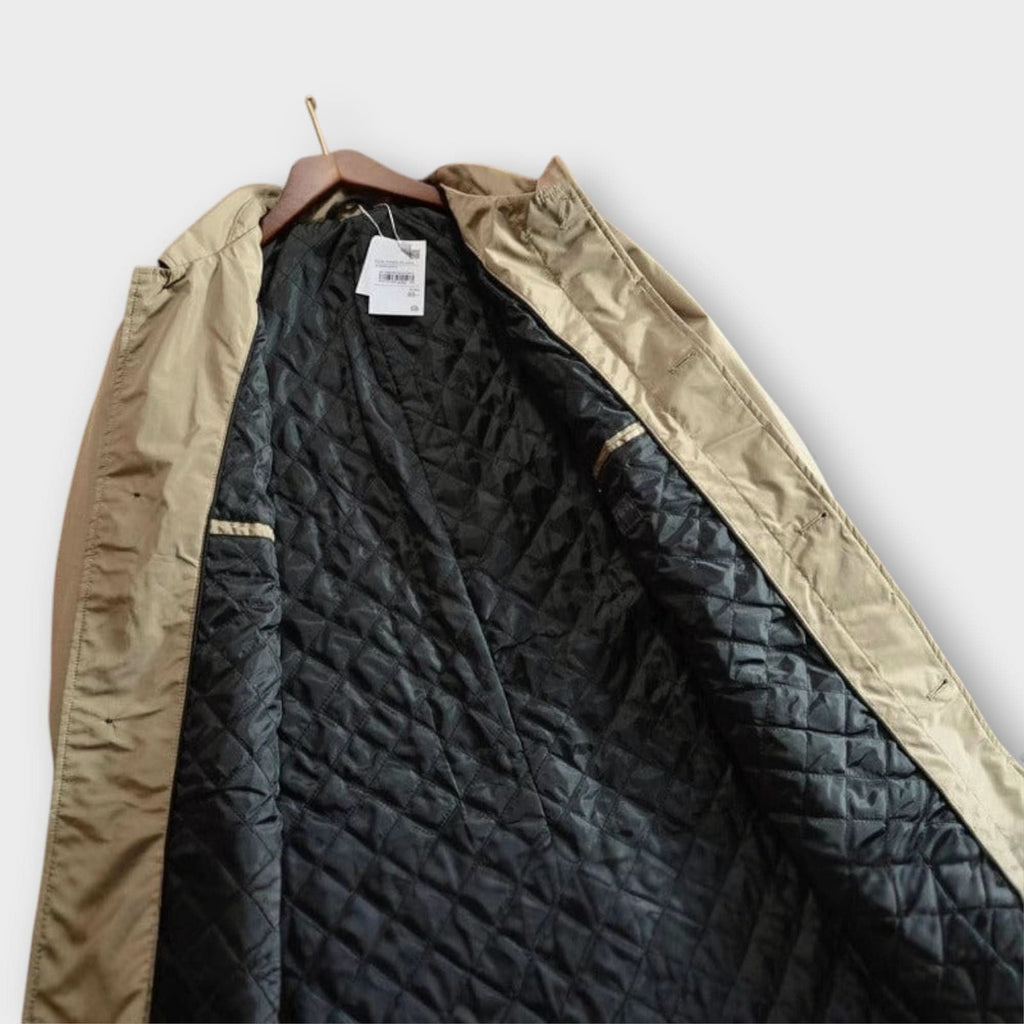 Close crop on the coat's fly-front placket and topstitching