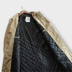 Close crop on the coat's fly-front placket and topstitching