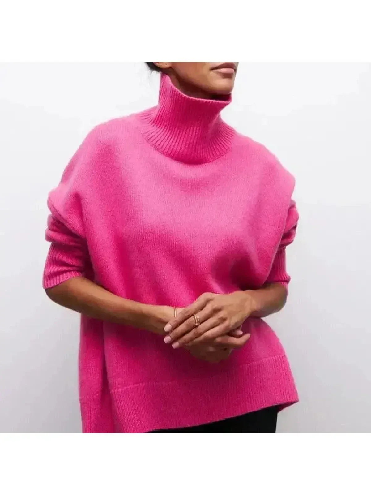 Oversized turtleneck sweater in Pink, shown against a plain studio background