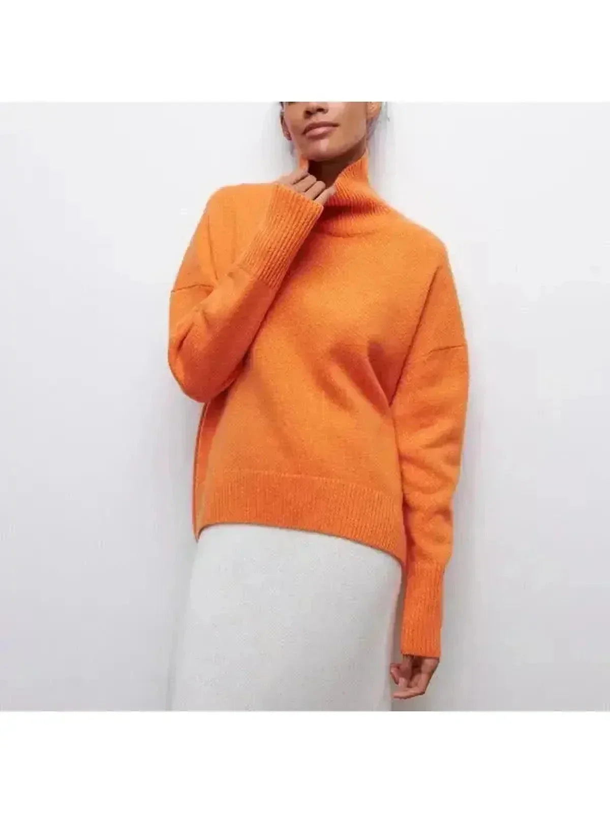 Oversized turtleneck sweater in Orange, shown against a plain studio background