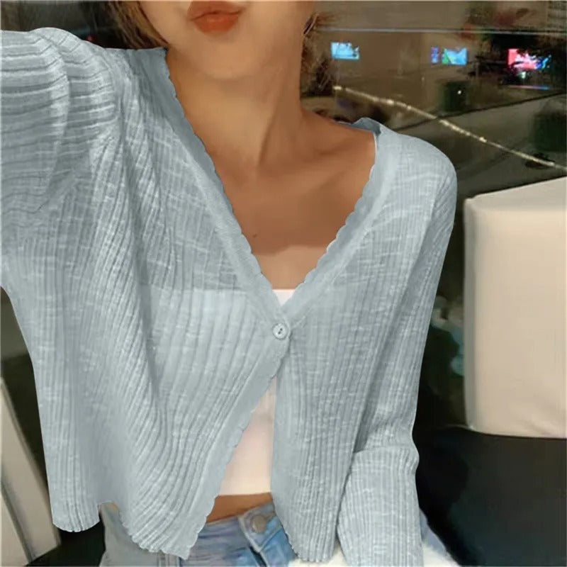 Blue ribbed knit cardigan worn open over a plain tee