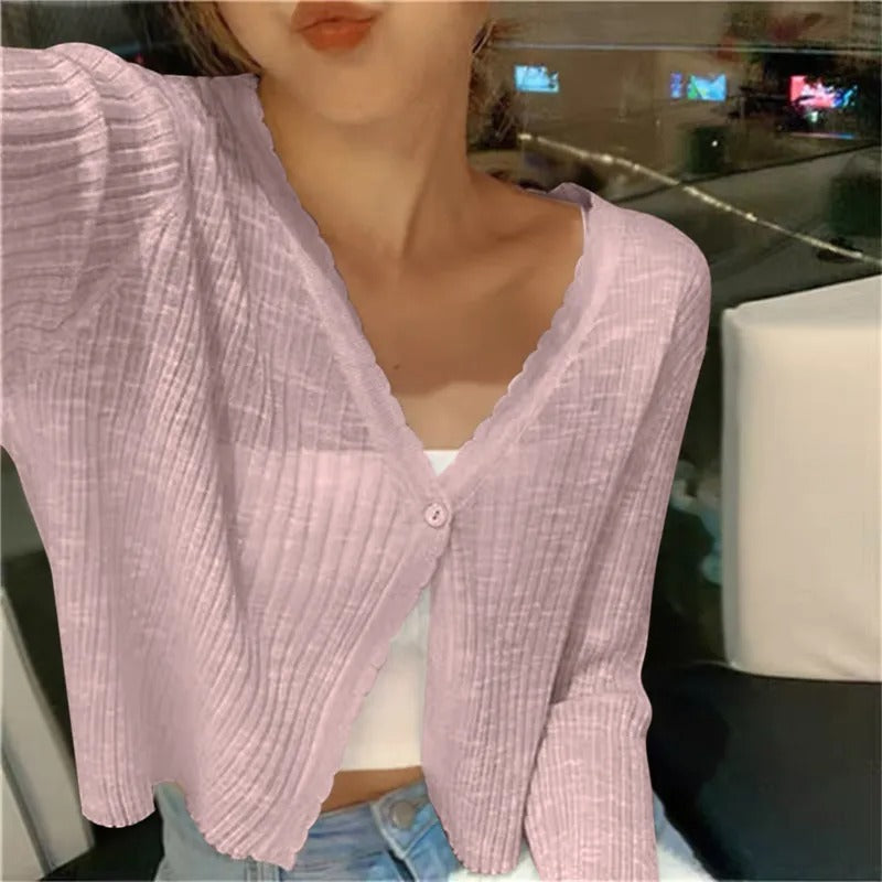 Pink ribbed knit cardigan shown open on a model