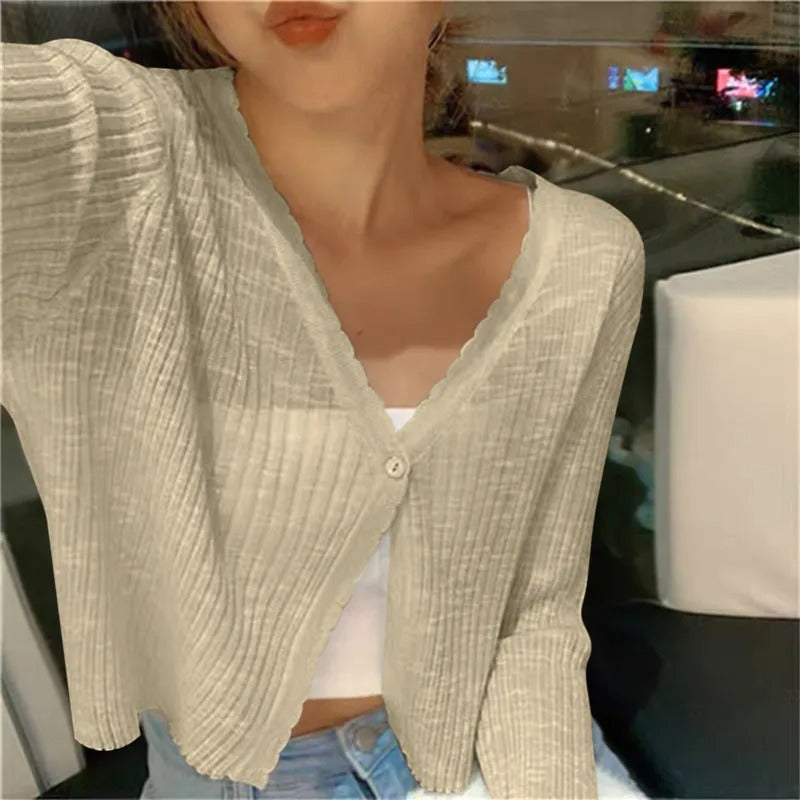 Beige ribbed knit cardigan layered over a light top