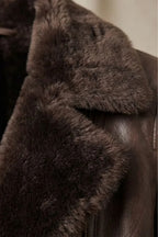 Brown leather jacket for women, detail of a zip-close front pocket and smooth leather finish