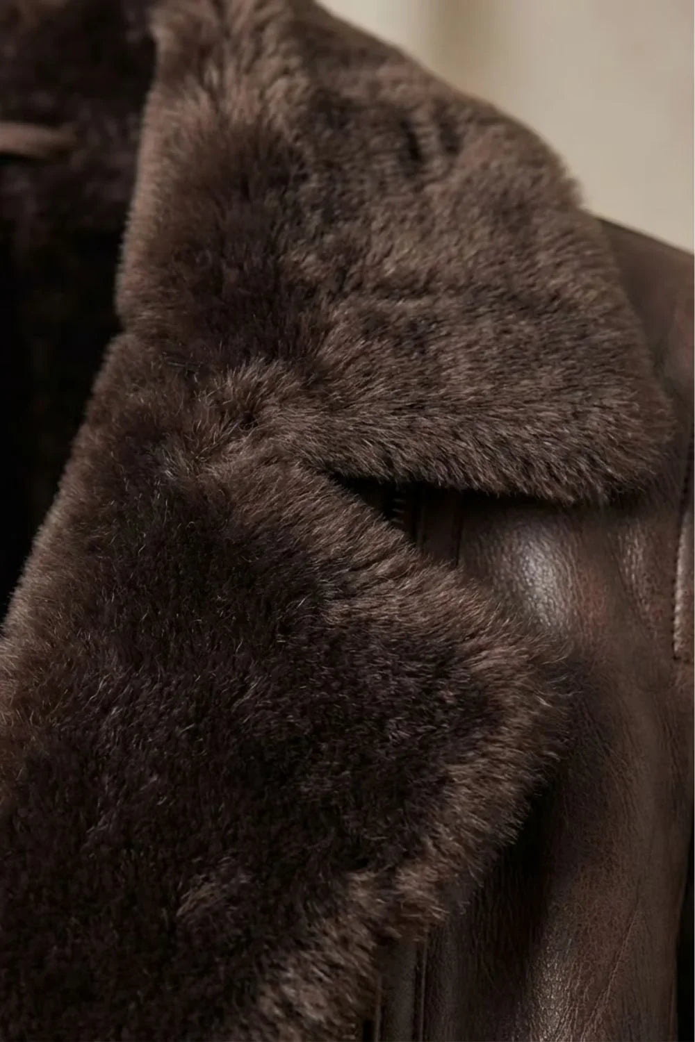Brown leather jacket for women, detail of a zip-close front pocket and smooth leather finish